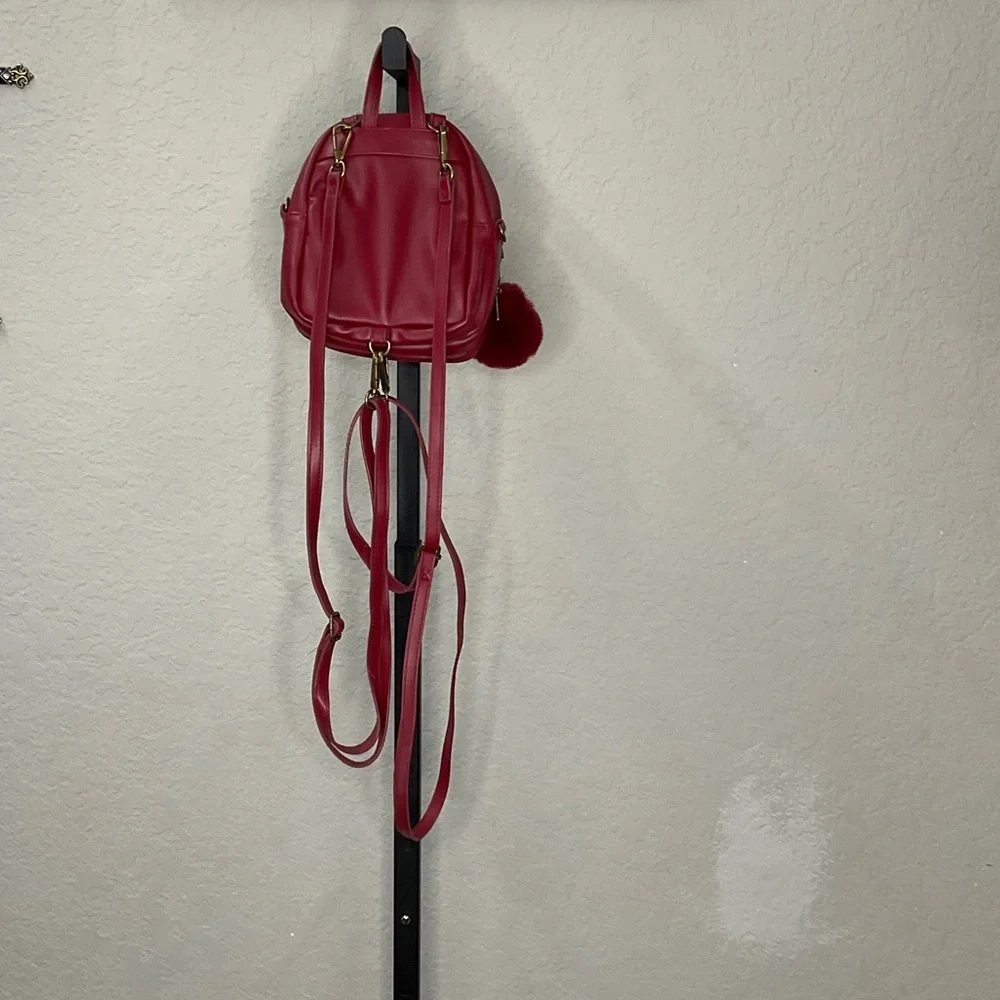Elegant Red Backpack with Pom Pom Charm
